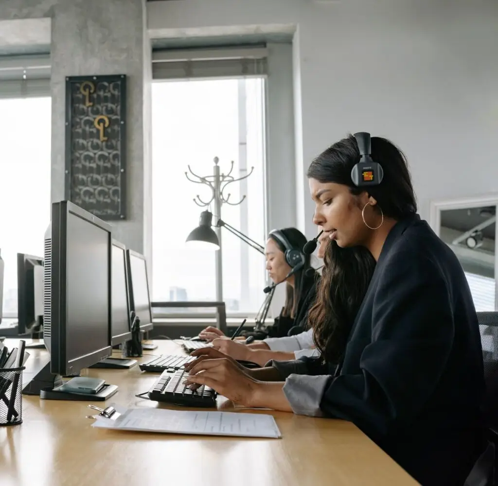 Support team members at workstations monitoring client system integrations